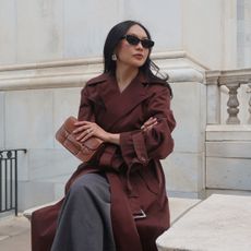 Stylish woman outside in a trench coat