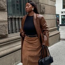 Nnenna Chem wears a suede midi skirt