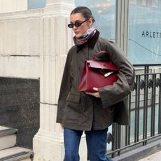 @sobalera wearing the Toteme Country Jacket with blue jeans, ankle boots, and a burgundy Hermes Kelly Bag in London