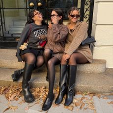 a group of three women wearing black boots